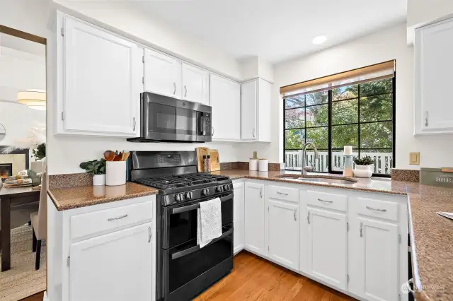 Bright white cabinets are complemented by rich granite countertops.