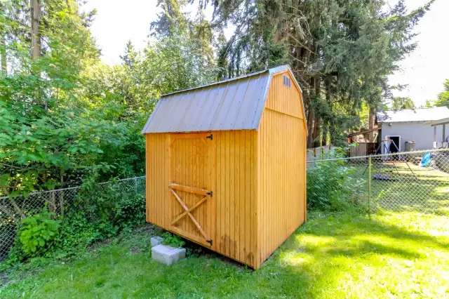 Newer shed offering lots of extra storage in addition to single car garage.