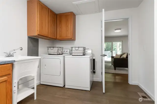 An abundance of storage, the laundry room offers built-in cabinets, laundry sink plus two storage closets