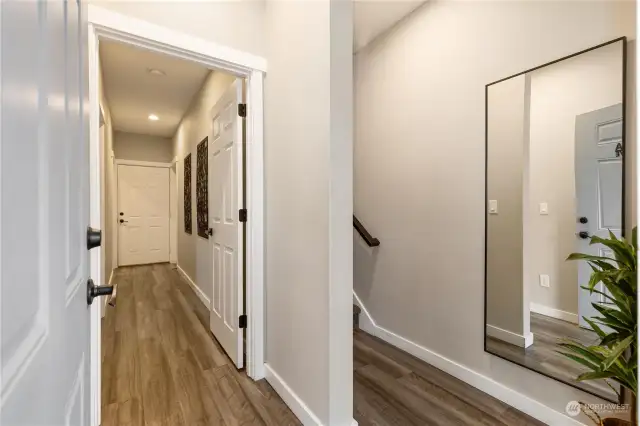 Entry way. Looking down hall to back door and to upstairs living area.