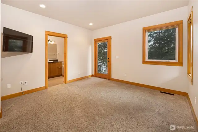 Primary bedroom w/en-suite bath and door to outside.
