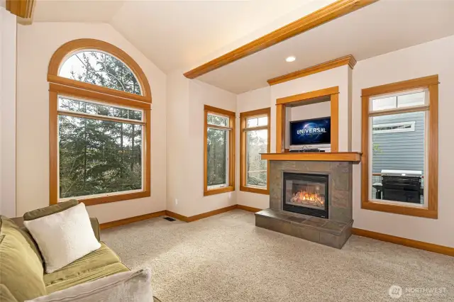 Comfortable size living room w/ wood burning fireplace & vaulted ceilings.