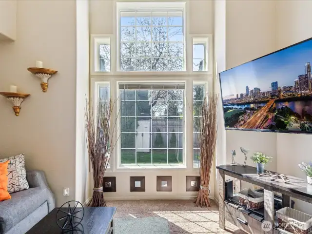 Living Room has gas fireplace & wonderful vaulted ceilings & wall of windows from bringing in the light year-round.