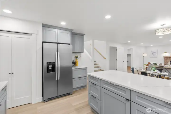 Large pantry behind the doors on the left. Kitchen opens to second dining and living areas.