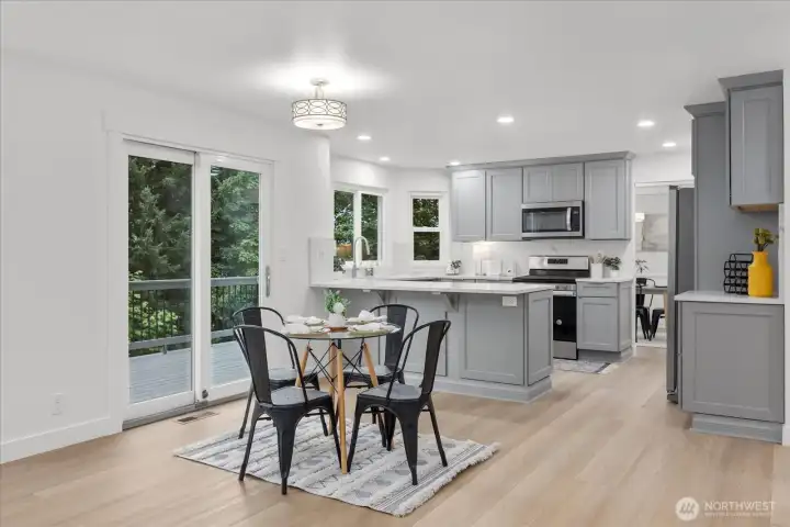 Second dining area with sliding glass door to Trex deck. Breakfast bar in kitchen for additional seating.