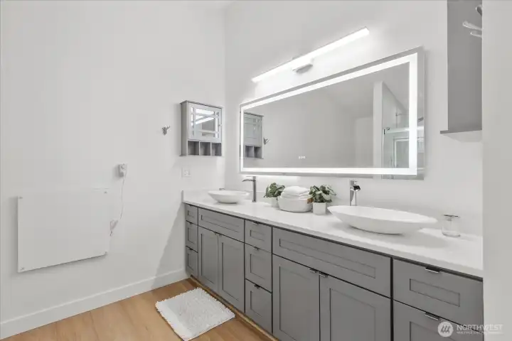 Updated vanity with grey shaker cabinets and drawers. Plenty of storage! Lux Hardwired LED Mirror with Color Changing Temperature, convection wall heater, luxury vinyl plank flooring, craftsman trim.