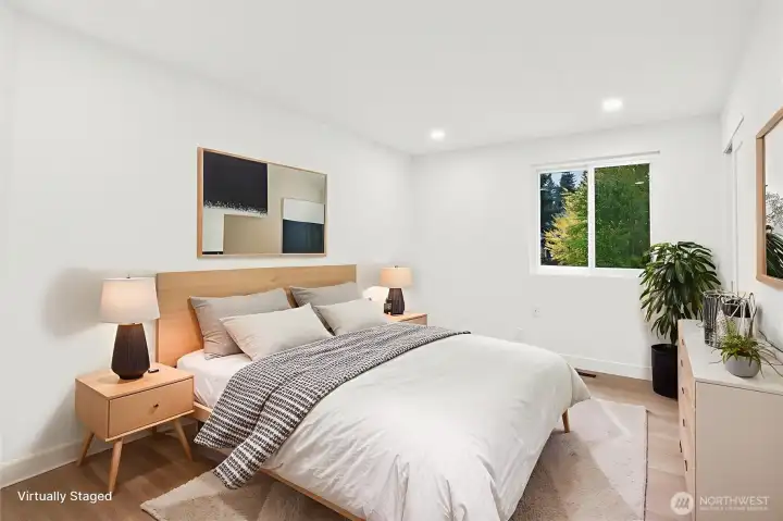 Bedroom 2. Luxury vinyl plank flooring, fresh paint, solid wood, single-panel white shaker doors with full wood craftsman bungalow casing craftsman trim, and adjustable canless lighting throughout the home.