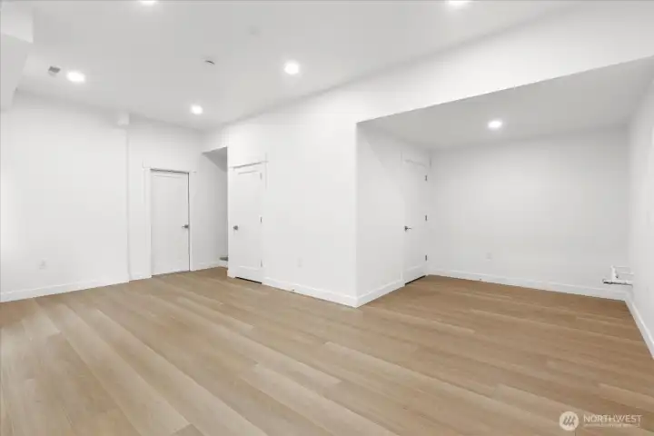 Fully renovated finished basement. Walk out the glass sliding door to a backyard patio. Rockwool insulation on the ceiling for noise reduction. Plumbed for a wet bar. Luxury vinyl plank flooring, fresh paint, solid wood, single-panel white shaker doors with full wood craftsman bungalow casing craftsman trim, and adjustable canless lighting throughout the home.