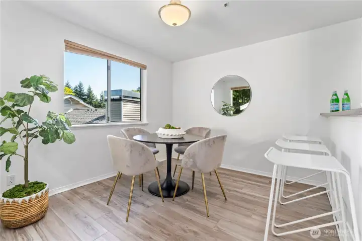 From the living room, glide over to the dining room with updated engineered hardwood flooring. This space is exquisitely illuminated with so much natural light from the dual walls of large windows.