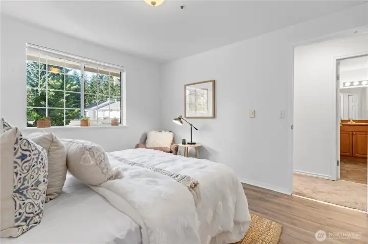 Enjoy warm afternoon sunlight with Western exposure in the primary bedroom.