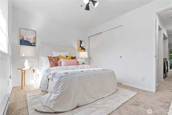 Another view of the guest bedroom showcasing the beautiful afternoon sunlight illuminating this bright space.