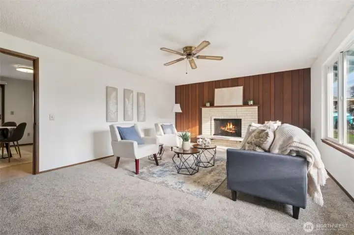 As you enter the house to the right is this very generous living room with unique brick work, wood burning fireplace.