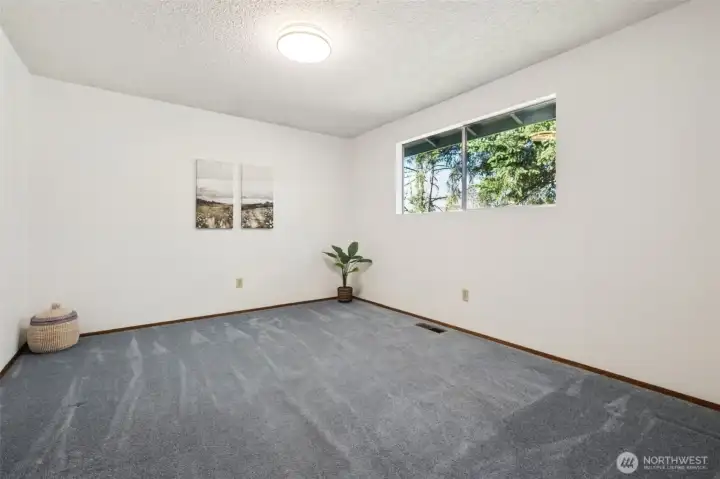 Bedroom #2 measures just shy of 13 feet by 11 feet. Room for everything! Window looks out onto the backyard.