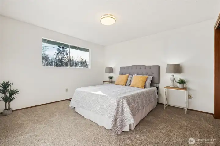 Primary bedroom with a whole wall of closets is also substantial. Measuring 16 feet by 12 feet. Has new carpet and a "refreshed" primary 3/4 bath attached.
