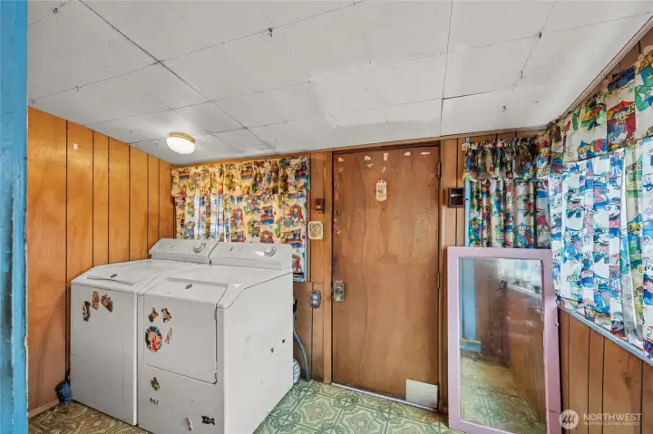 Side entry leads to a functional utility mud room.