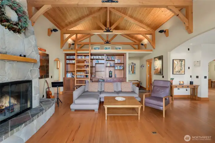 Built-ins with rolling library ladder up to the loft