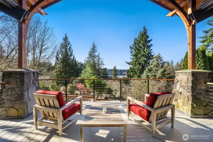 Large deck with cable railing, stone and timber columns, water view!