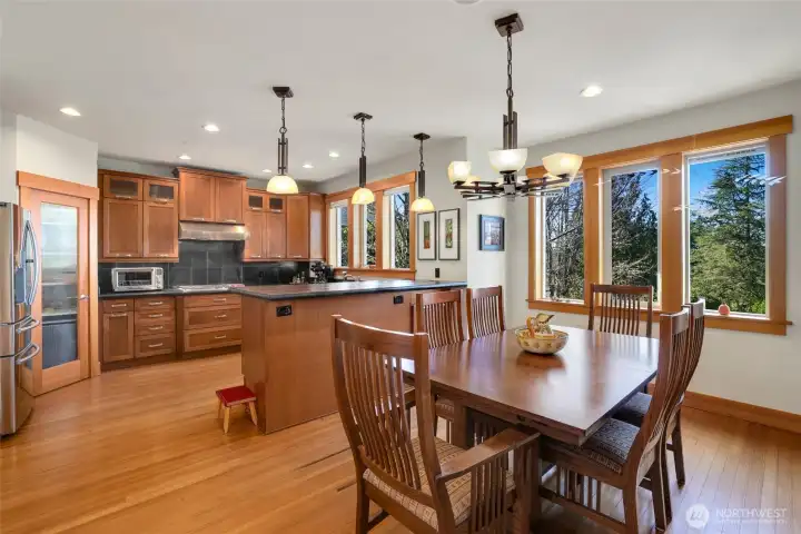 Dining and kitchen with gorgeous wood cabintry and walk-in pantry