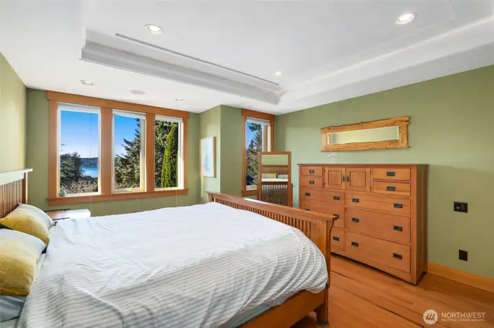 Serene primary bedroom with water views