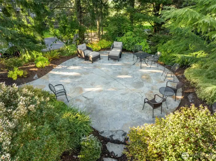Seating area surrounded by lush landscaping