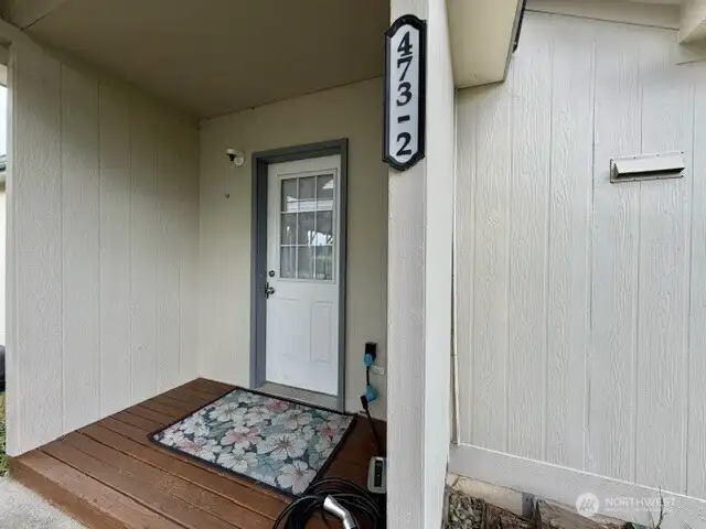 This porch is covered for rainy days & has the outlet for electric car charging.  Save money fueling your car.