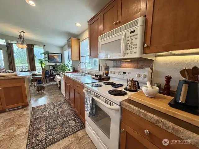 Your kitchen is open to living areas & dining & features plenty of counter space