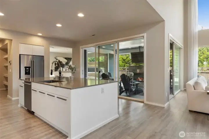 Kitchen with access to covered patio with fireplace