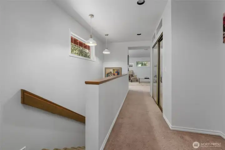 Stairs up to first primary room with hall leading to it.