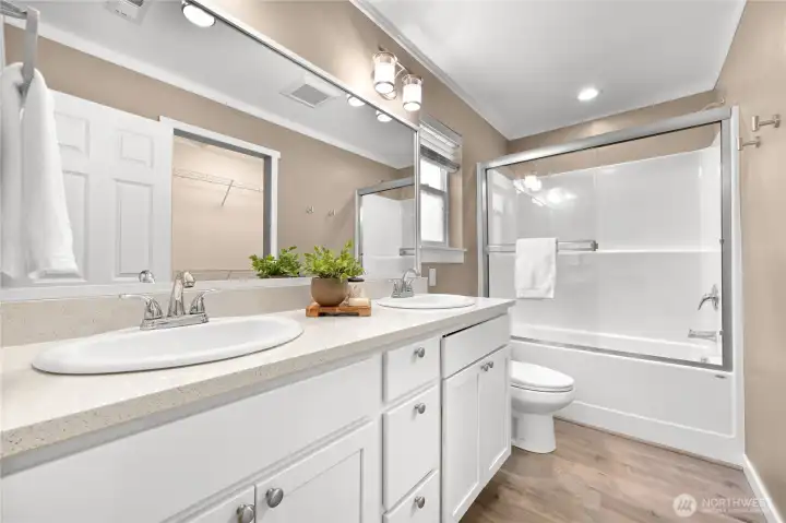 Double vanity with quartz counters in the primary bathroom Double vanity with quartz counters in the primary bathroom