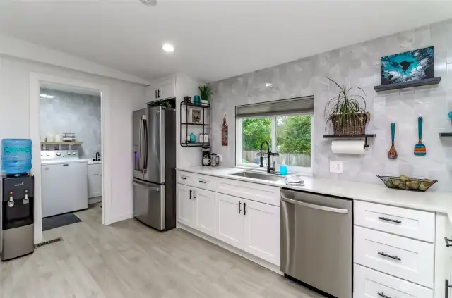 This beautiful kitchen boasts of soft close cabinetry, quartz countertops, and stainless-steel appliances.