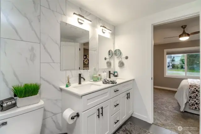 Double sink vanity has plenty of personal storage space with handsome fixtures.