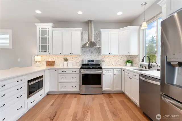 Well appointed kitchen with quartz countertops.