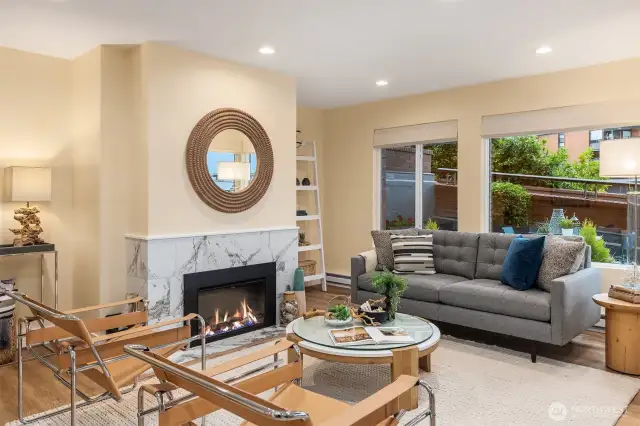 Living Room looking to side portion of patio. Electric fireplace insert. Wood burning fireplace behind electric as an option (Currently not staged).