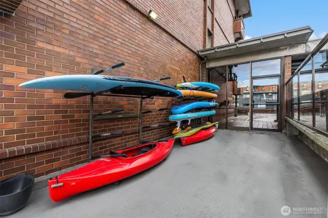Common storage for water craft next to pool. You can see through door to the Unit's parking area. Super convenient access.