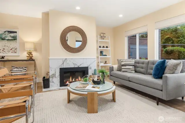 Living Room with Electric Fireplace Insert. (Wood buring fireplace behind operational if preferred.) Note garden wall in outside Patio (Currently not staged).