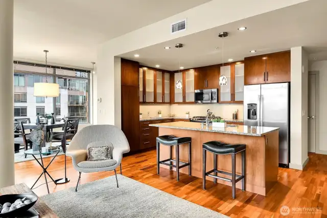 Open, social layout with living & dining areas flowing around the kitchen.