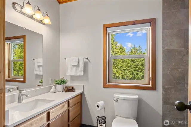 The primary bath has all new surfaces! New quartz counters, tile floors and tile shower.