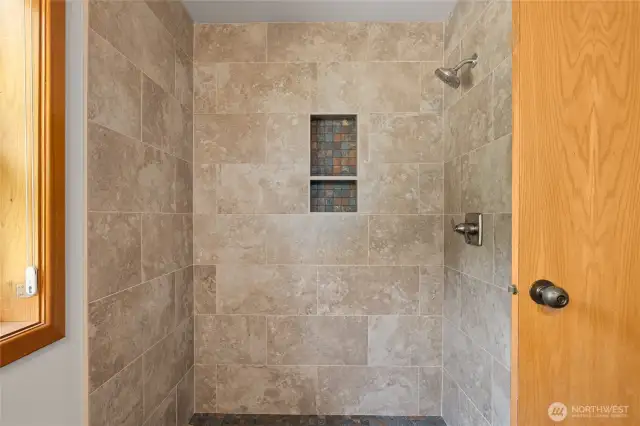 New tiled shower in primary bath.
