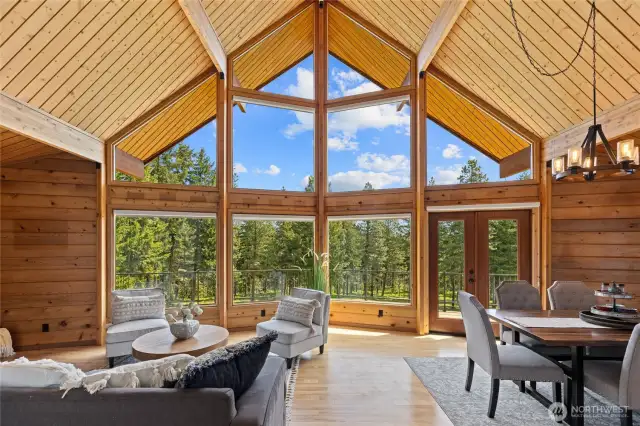 A timeless wall of wood-wrapped windows pairs beautifully with exposed beams and tongue-and-groove ceilings.