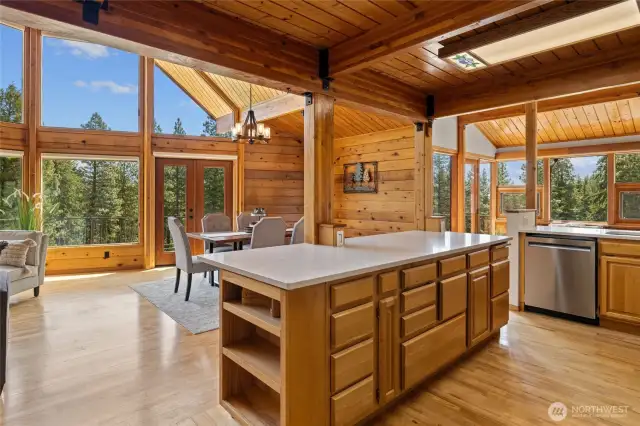 The open-concept kitchen features an inviting eating bar, scenic views, and the perfect layout for gathering.