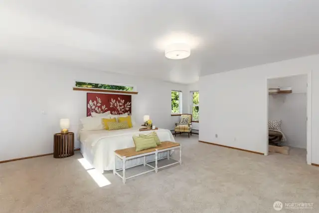 Main level primary with not one but two walk in closets and a private bath with jetted tub, shower, and double sinks.