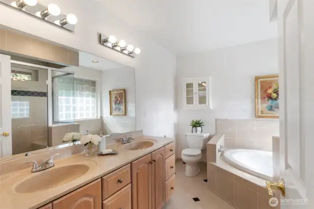 Primary bath with jetted tub, shower, and double sinks.