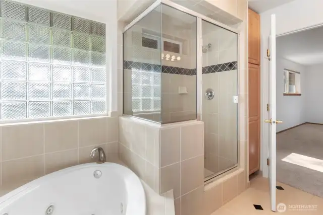 Primary bath with jetted tub, shower, and double sinks.