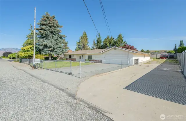 Large driveway on right provides access for Sunrise East equipment, but also accesses a utility storage area at rear of the home's garage