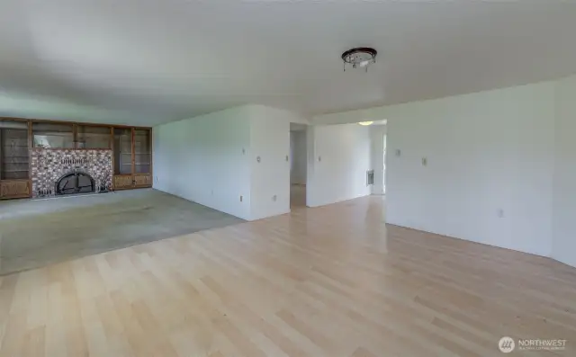 Large, bright living room with fireplace and wall-to-wall custom storage