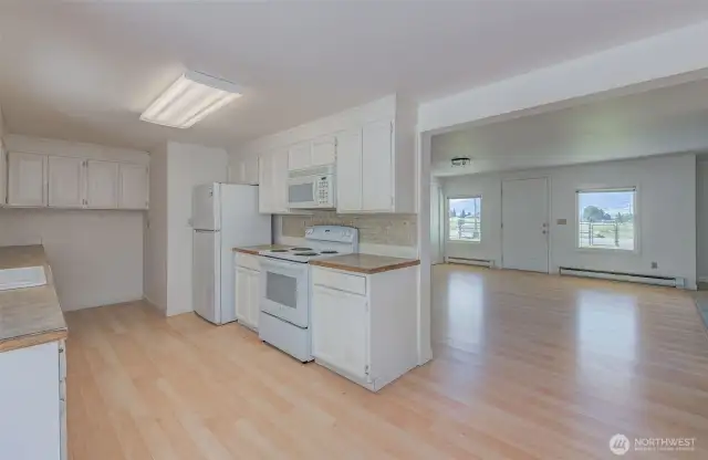 Standing in a small breakfast area looking toward kitchen and dining room
