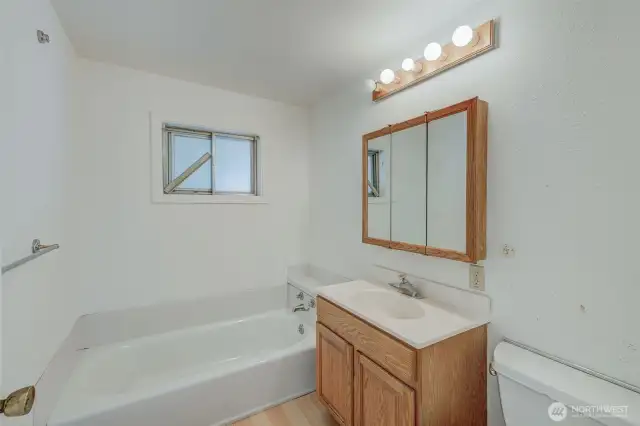 Full bathroom next to Bedroom 1, living, kitchen and dining rooms
