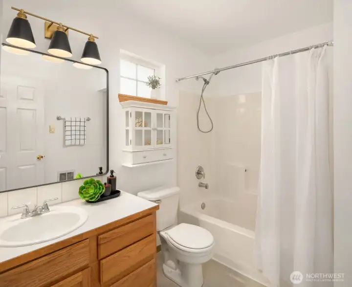Refreshed primary bathroom with new mirror and vanity light!