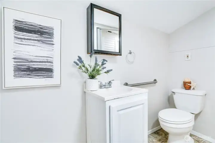 Tucked at the back of the home for added privacy and convenience, this half bath is perfect for guests and everyday ease.