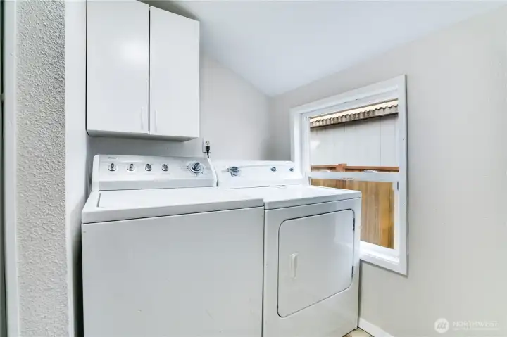 Thoughtfully integrated into the half bath, the main-floor laundry enjoys natural light from a cheerful window and durable flooring designed for busy routines. The washer and dryer stay!
